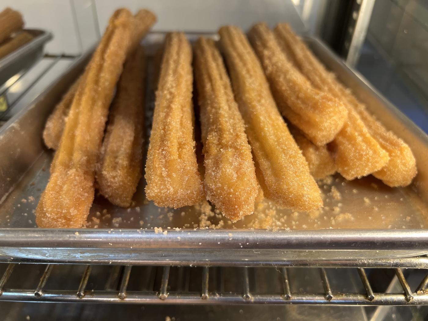 Fresh churros in the display case at Diana's Bakery.